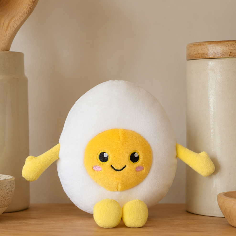 Boiled Egg Besitos plush toy displayed on a warm oak kitchen shelf beside neutral ceramics and wooden utensils Plushies South Africa