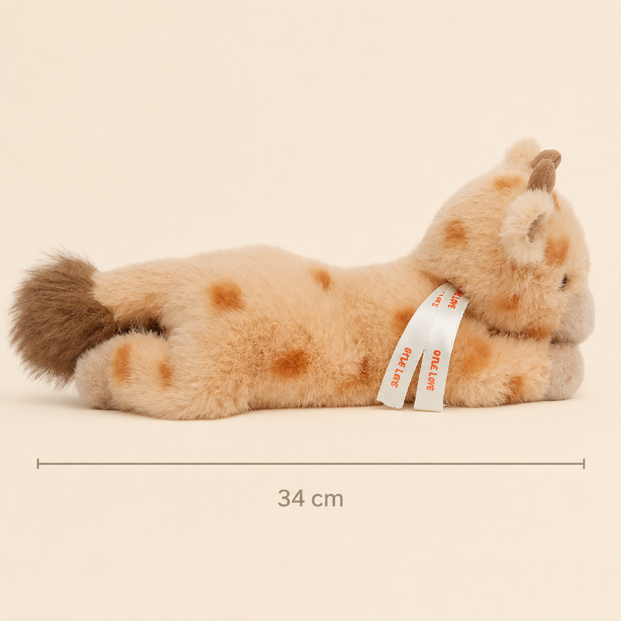 Side view of One Love Snuggles Willow Giraffe plush toy showing its 34 cm length